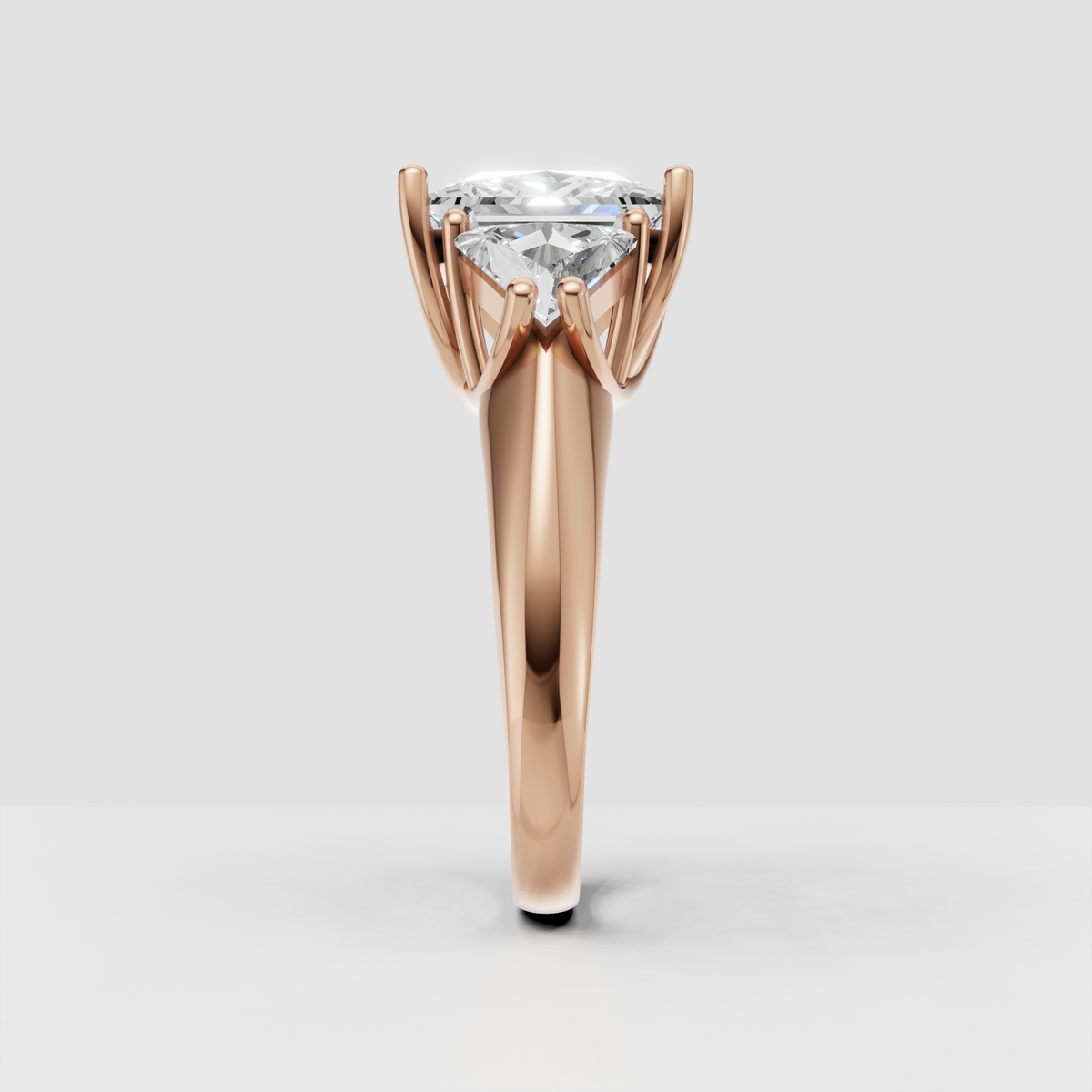 Close-up of princess cut three stone diamond engagement ring