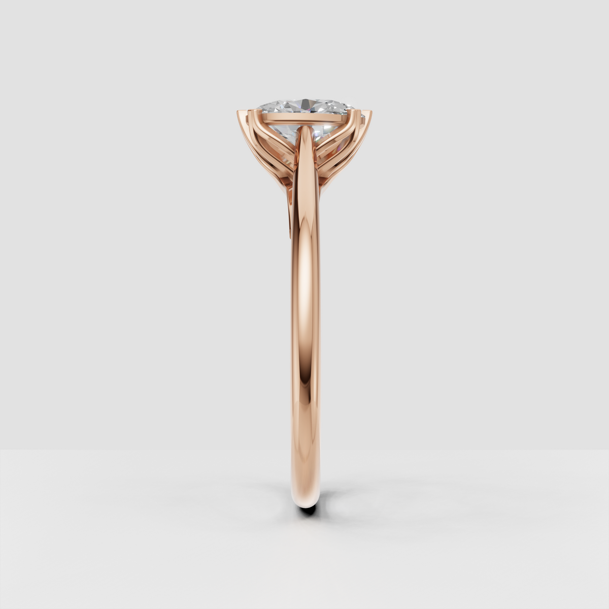 Elegant oval solitaire ring with sculptural yellow gold under-gallery