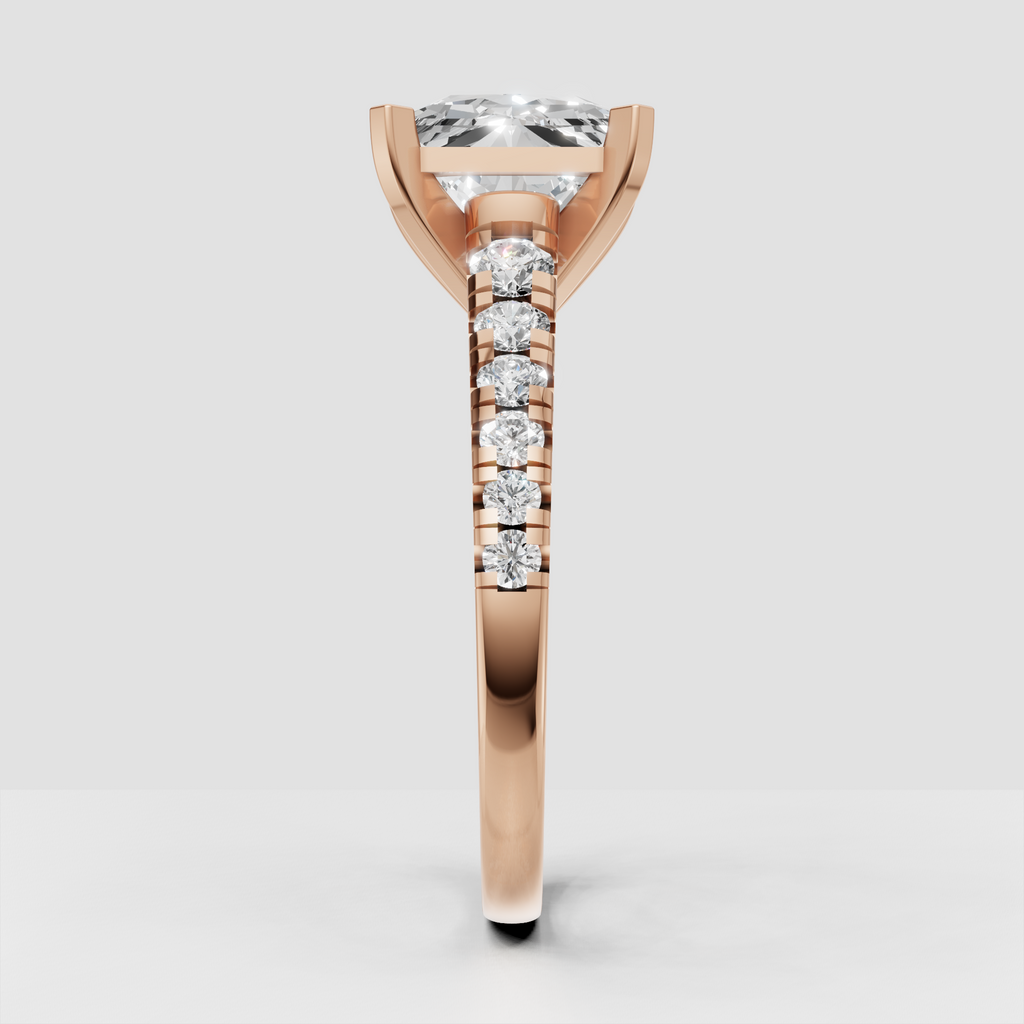 Four-prong radiant cut diamond ring with pavé-style shoulder detailing