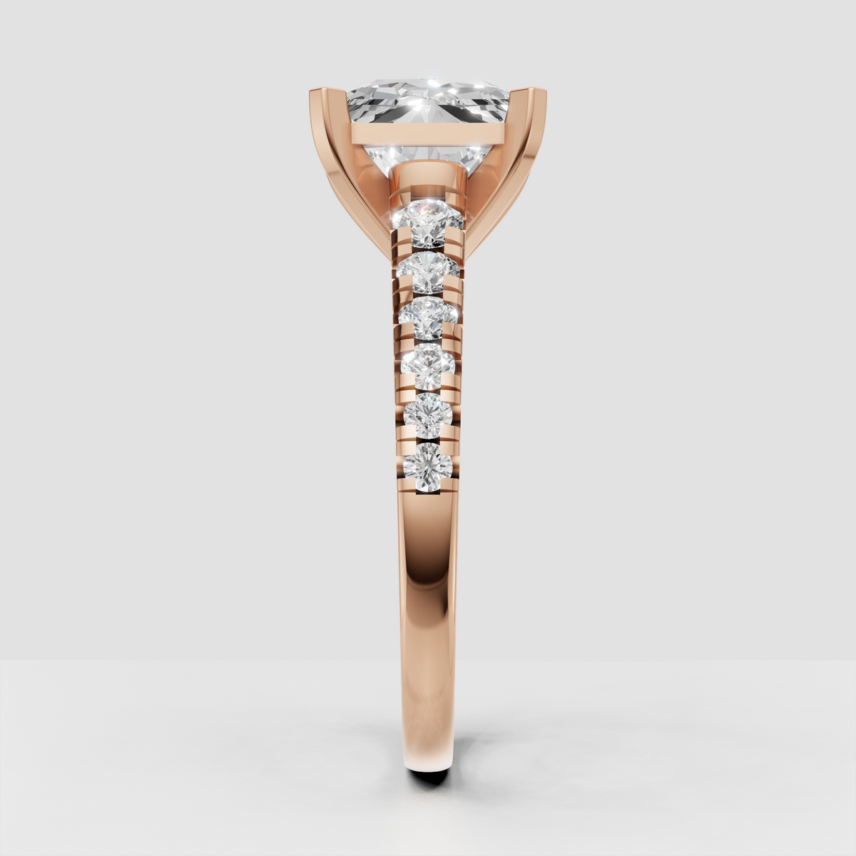 Four-prong radiant cut diamond ring with pavé-style shoulder detailing