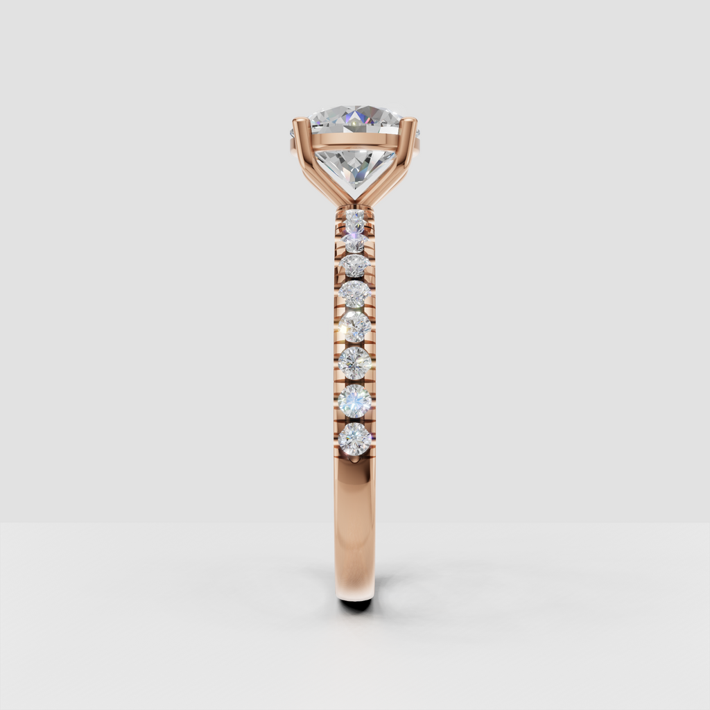 Close-up of round brilliant center diamond with gold prongs