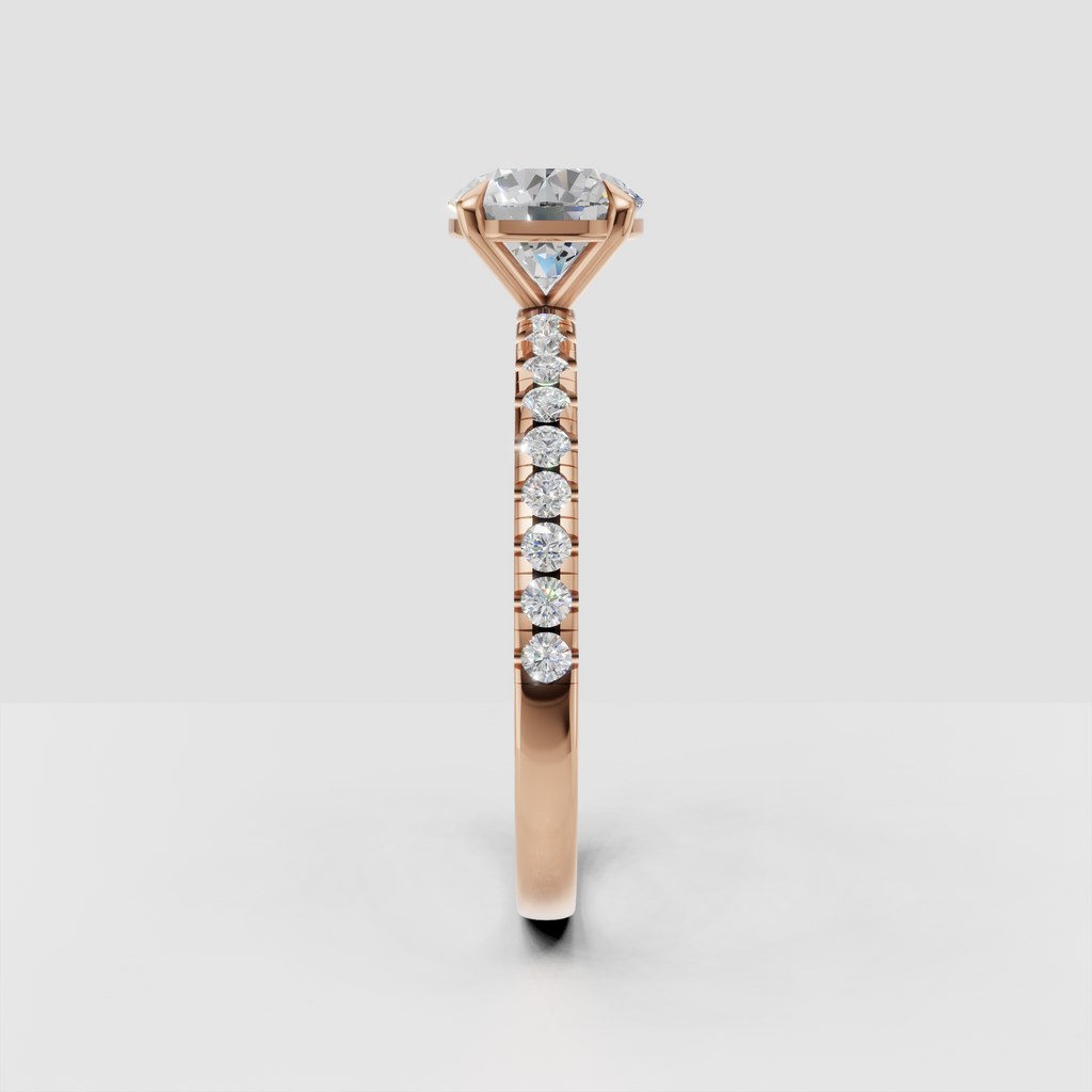 Side profile of yellow gold round Diamond engagement ring with basket-style gallery