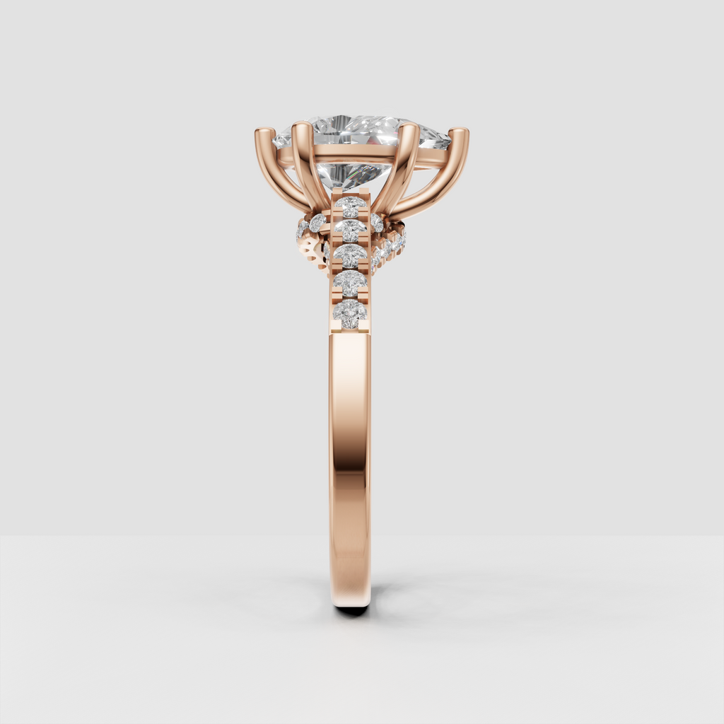 Pear diamond solitaire style ring with sparkling round stones on split shoulders
