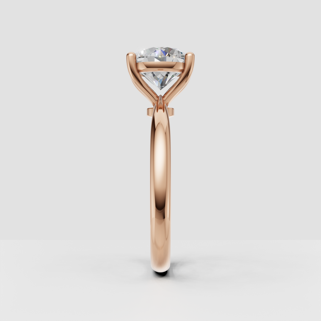 Round diamond engagement ring with tapered shoulders and gold band