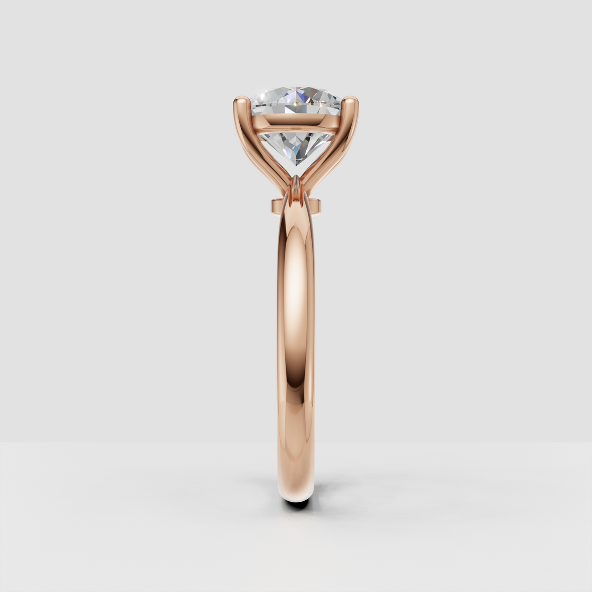 Round diamond engagement ring with tapered shoulders and gold band