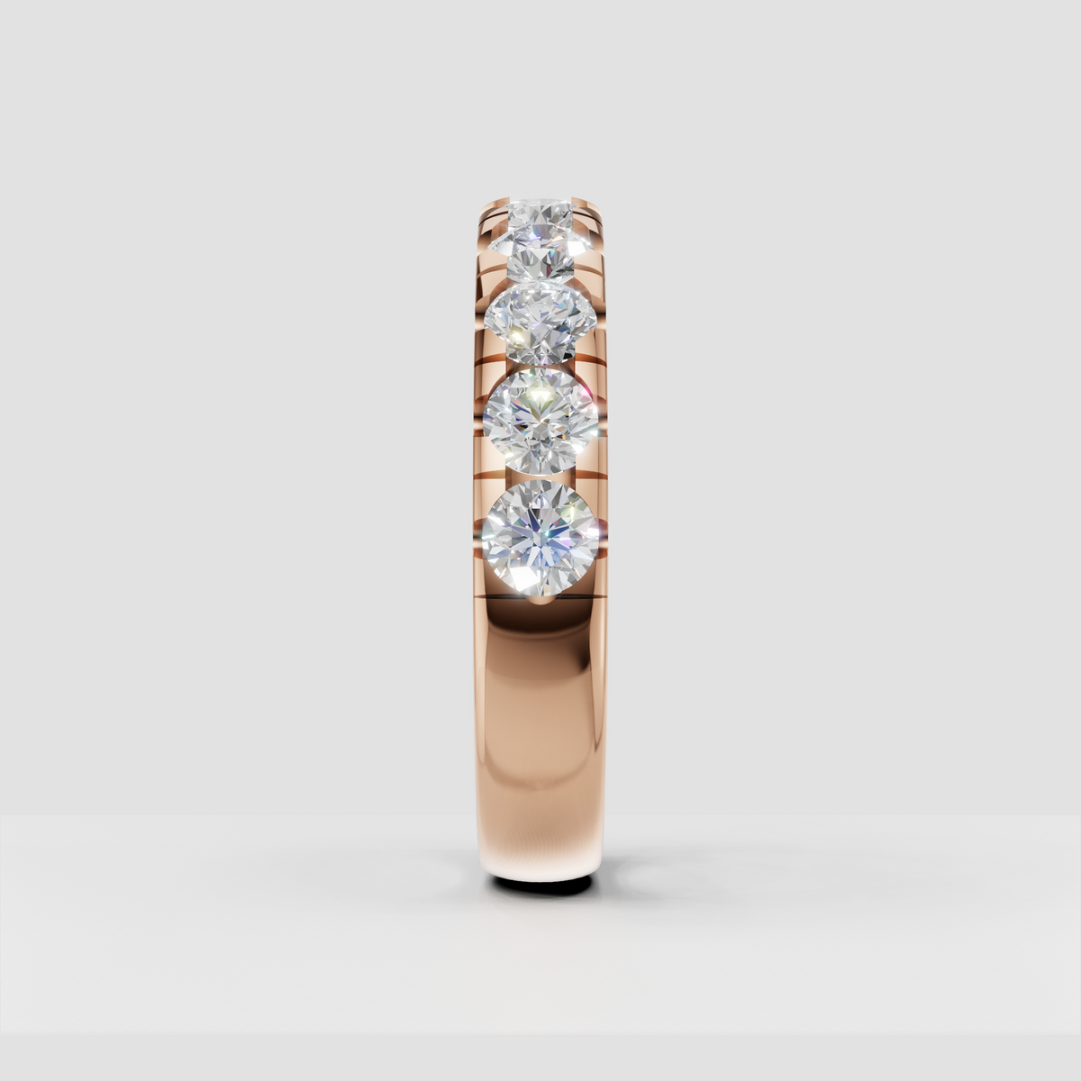 Side view of round diamond eternity ring showing open gallery construction