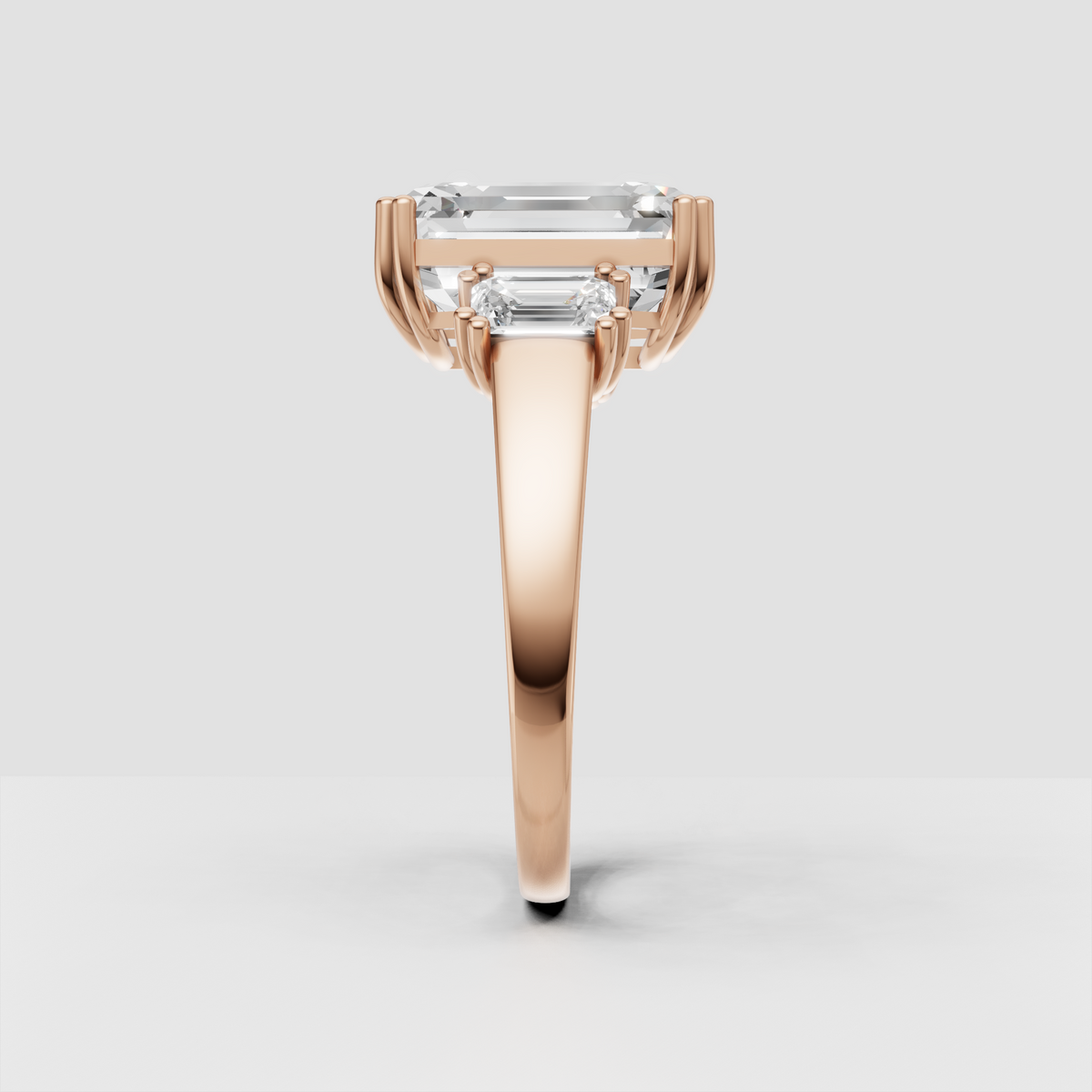 Emerald cut three stone ring with substantial gold band