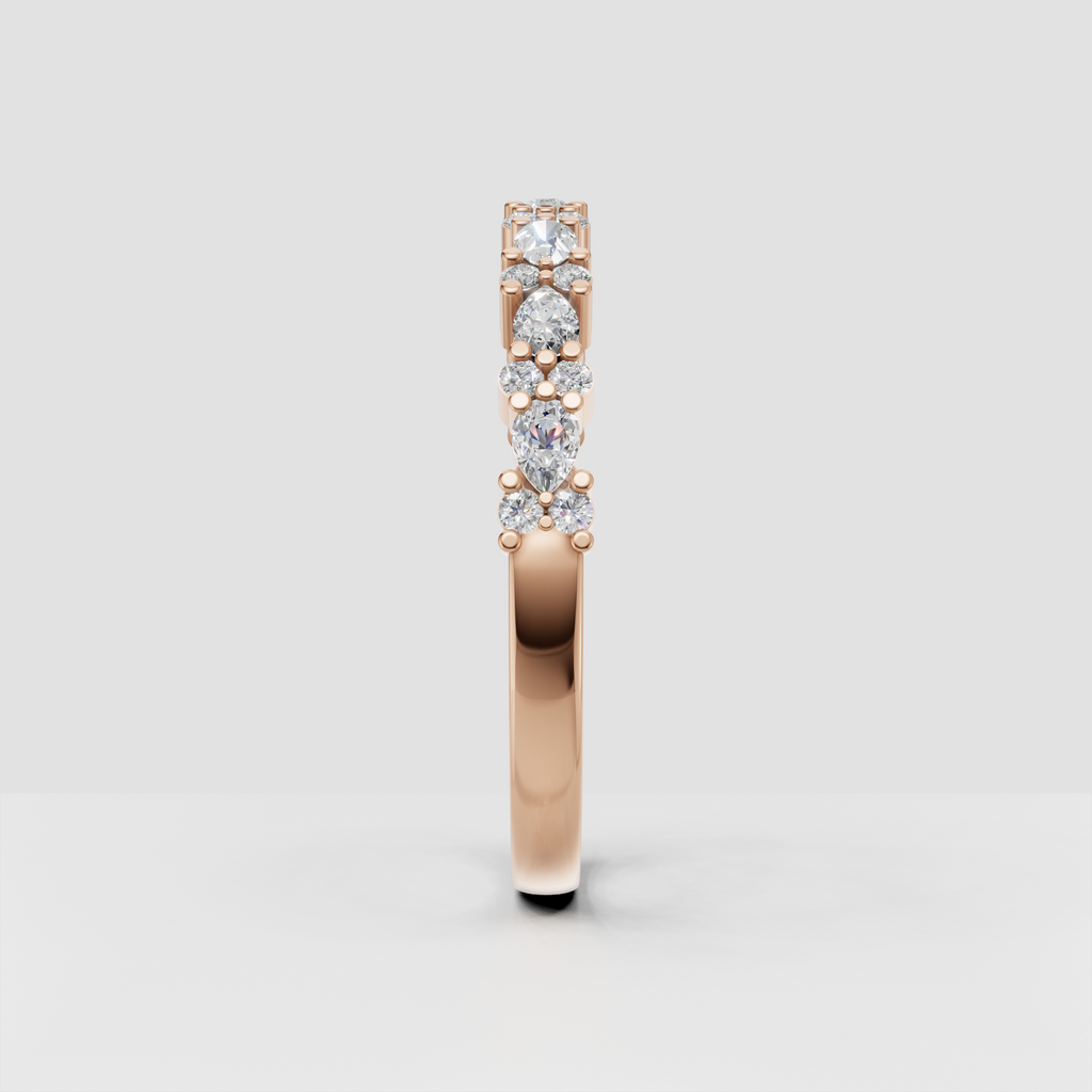 Polished yellow gold band with round and pear diamond accents