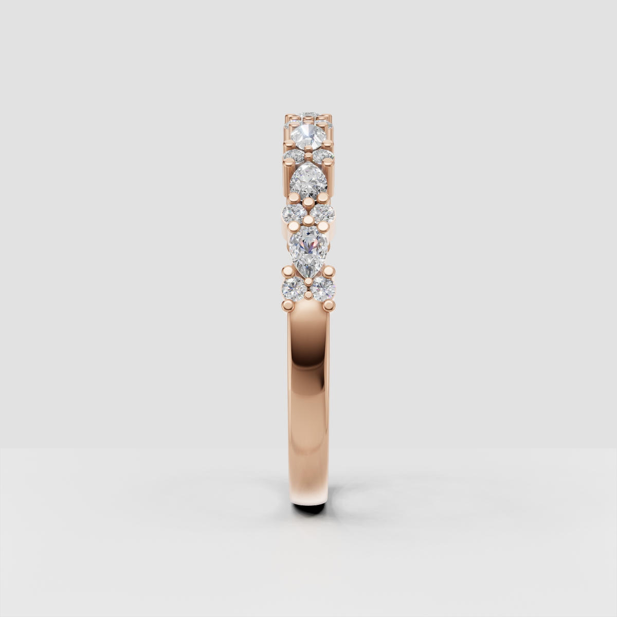 Polished yellow gold band with round and pear diamond accents