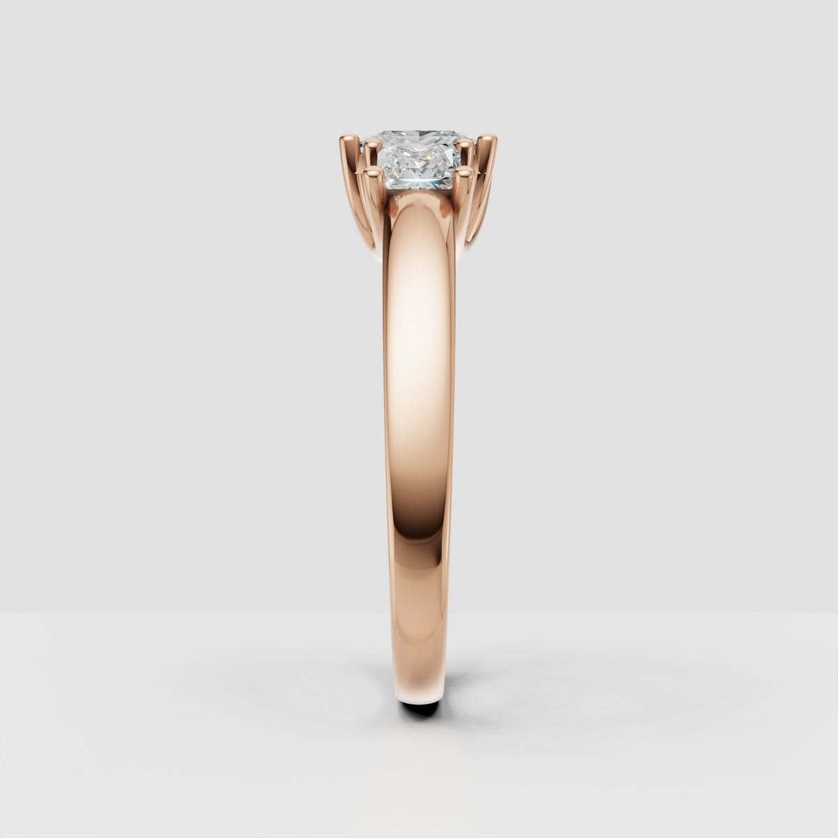 Side view of princess cut three stone diamond ring