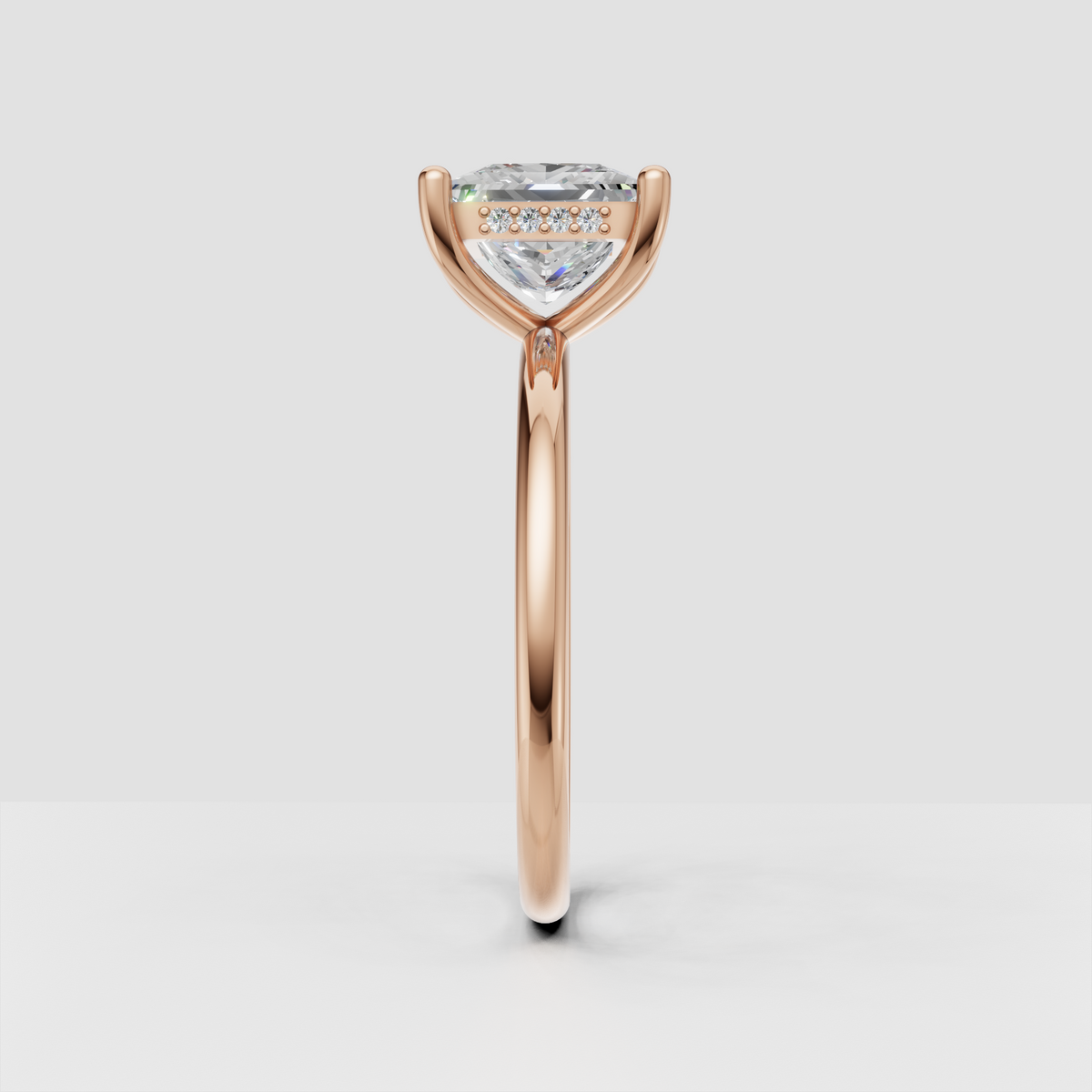 Yellow gold solitaire engagement ring featuring a brilliant princess cut diamond and sleek rounded band