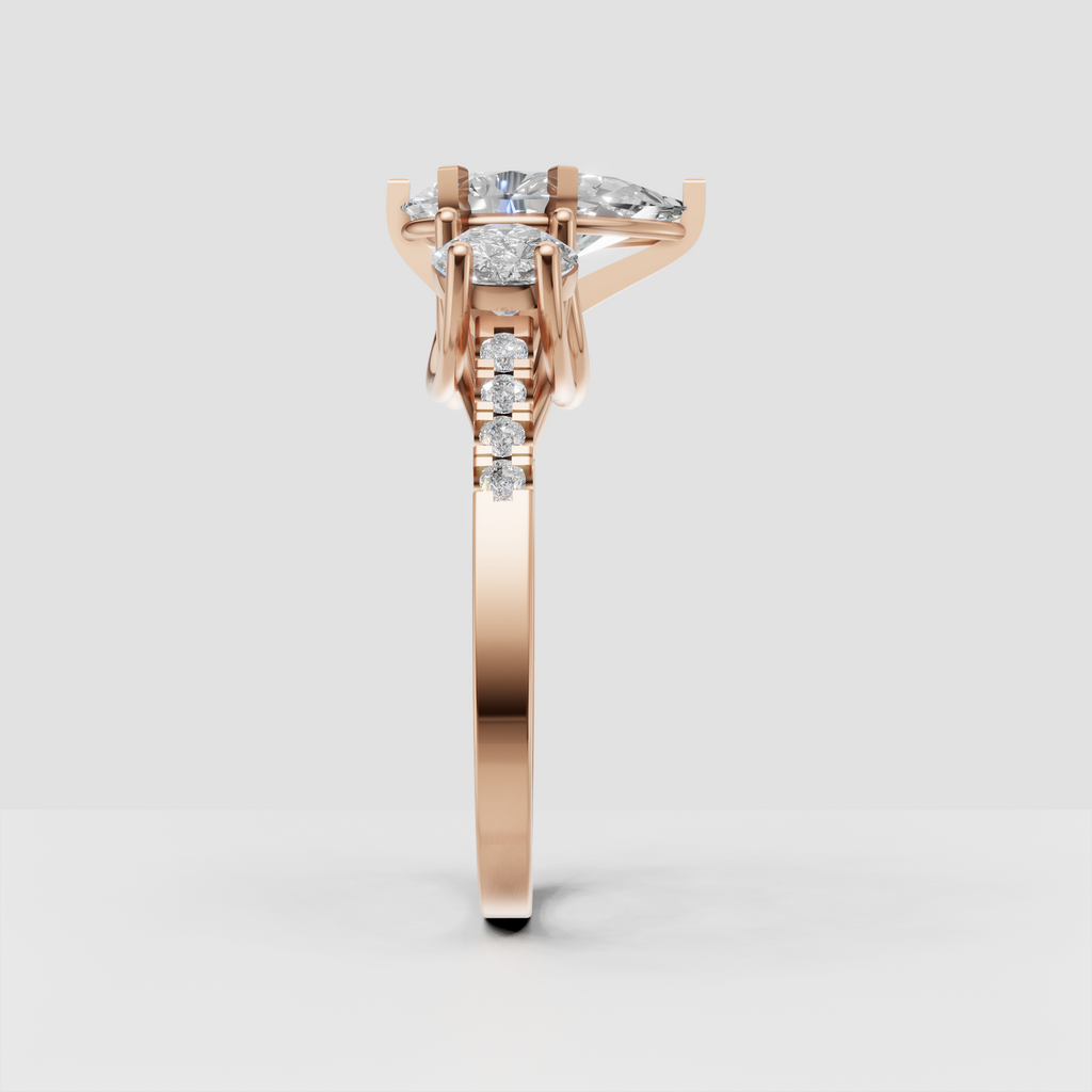 Three stone engagement ring featuring pear and round brilliant diamond shapes