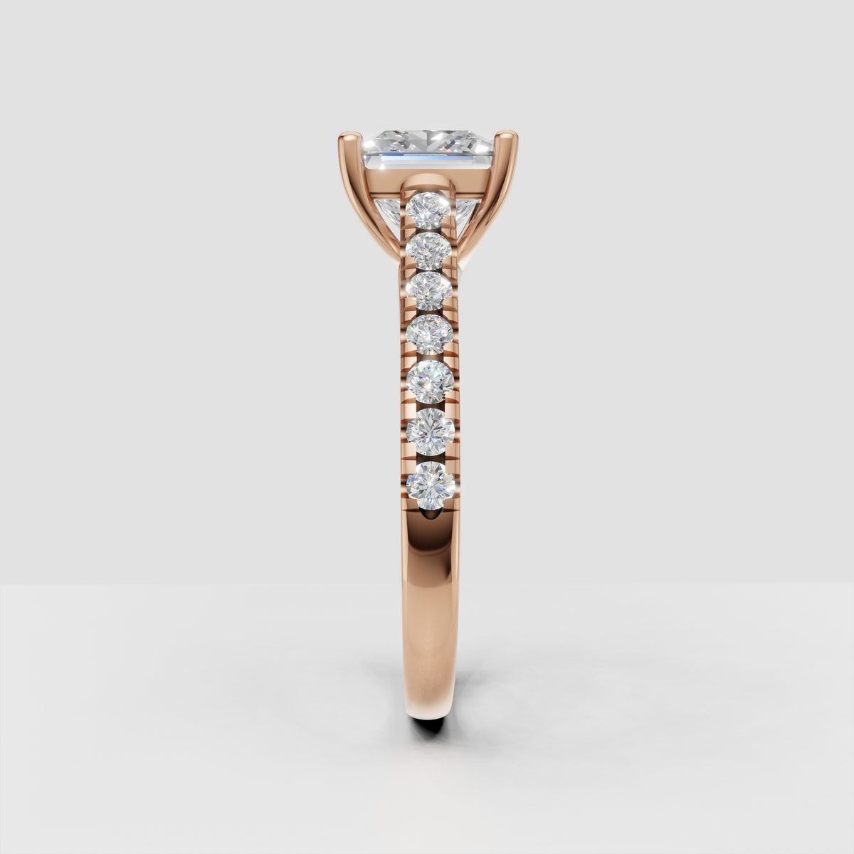 Polished yellow gold ring featuring a princess cut center diamond