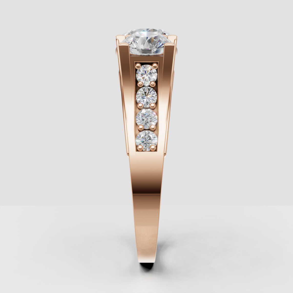 Side profile of yellow gold round Diamond three-stone engagement ring