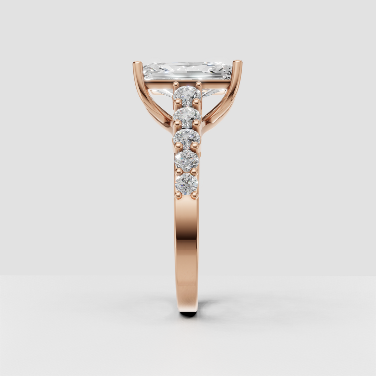 Radiant cut center stone ring with four-prong setting and diamond accents