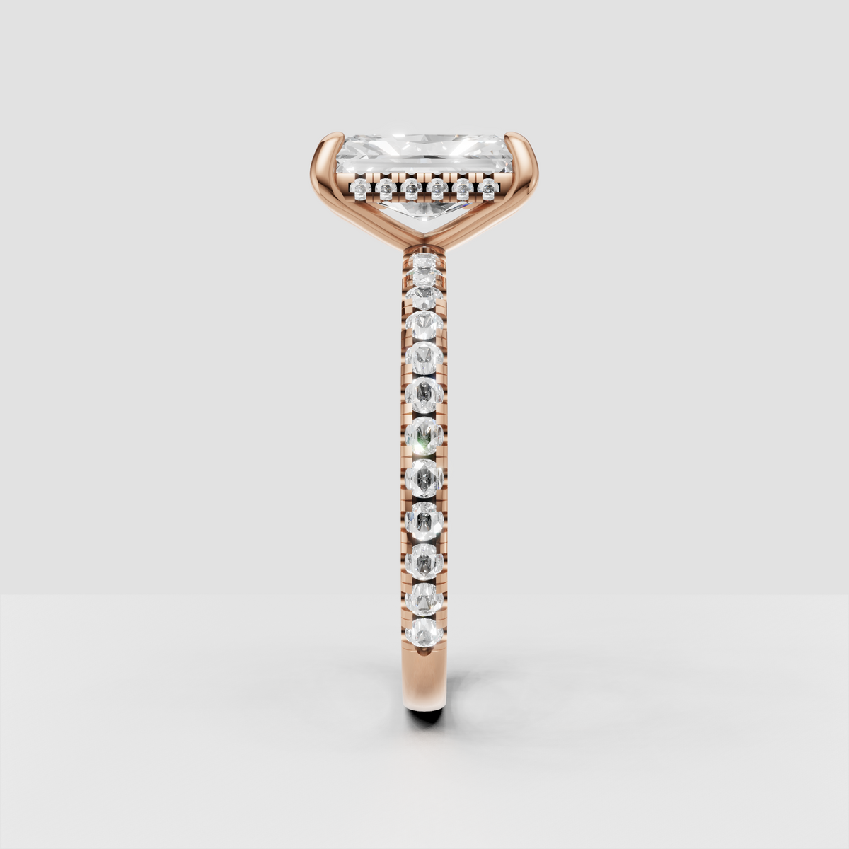 Elongated radiant cut canter diamond in four-prong solitaire setting