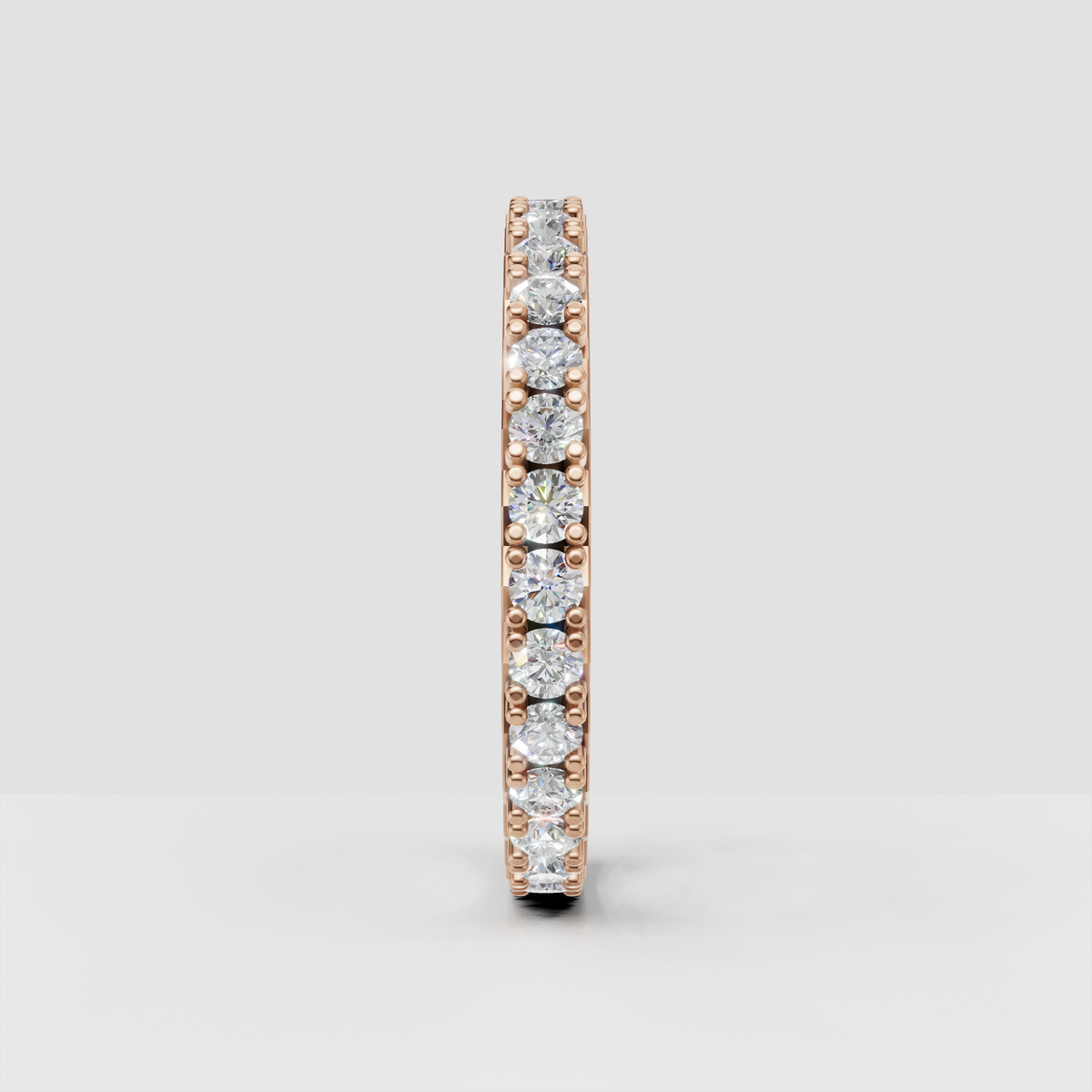 Elegant round cut diamond eternity wedding band with polished rose gold finish