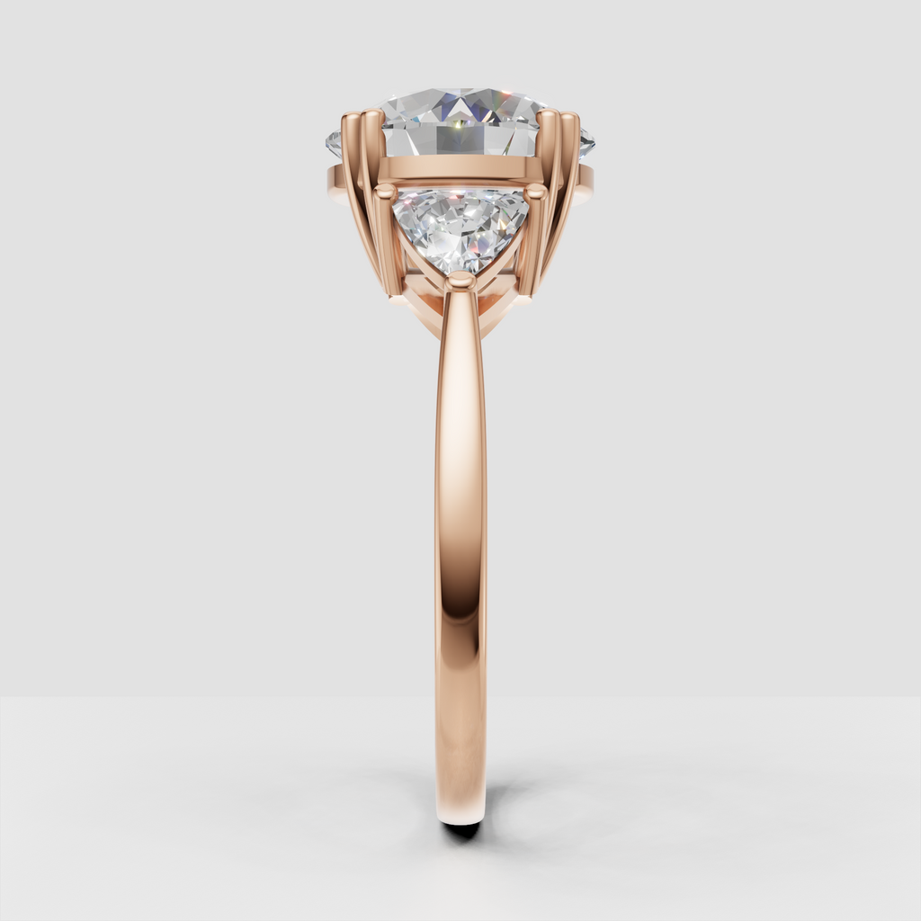 Round-cut center diamond with pear side stones in yellow gold