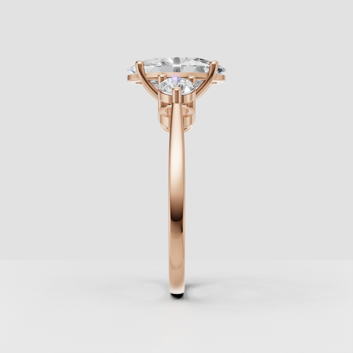 Elegant three stone diamond ring featuring an oval center stone