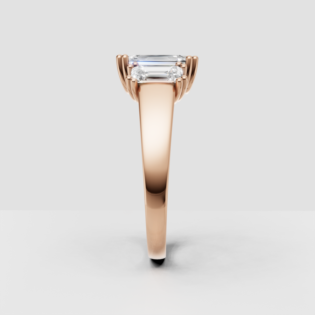 Emerald cut center stone framed by matching side Diamonds