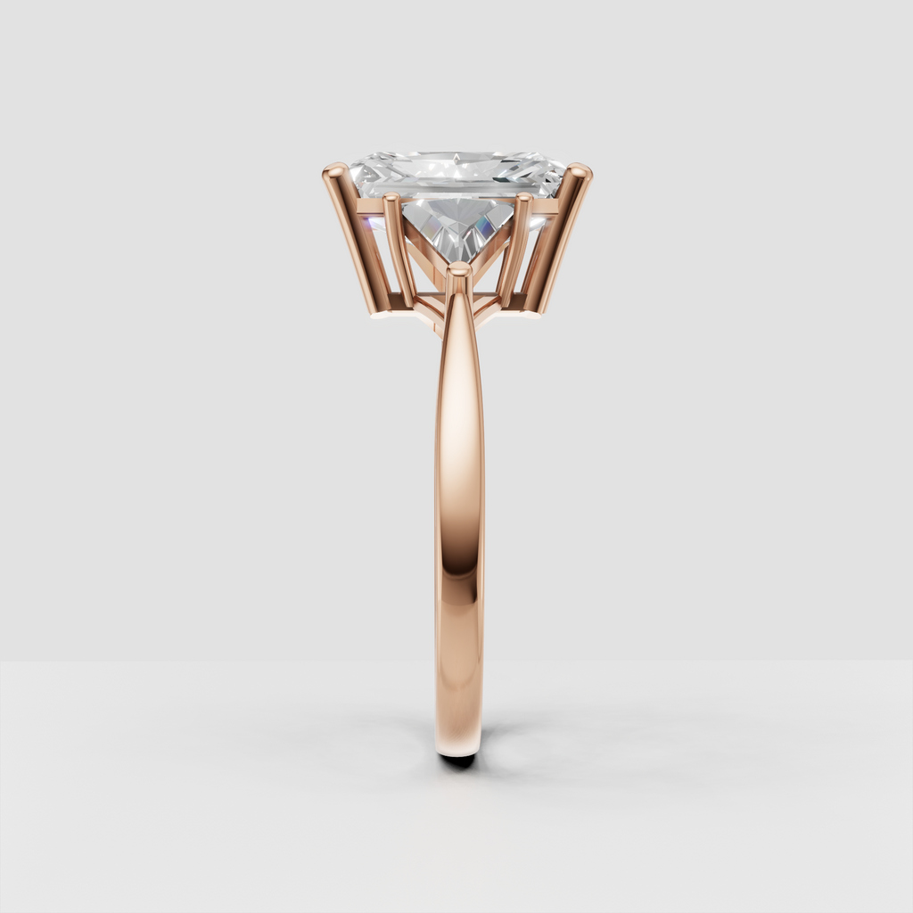Yellow gold three-stone diamond ring with elongated radiant center stone