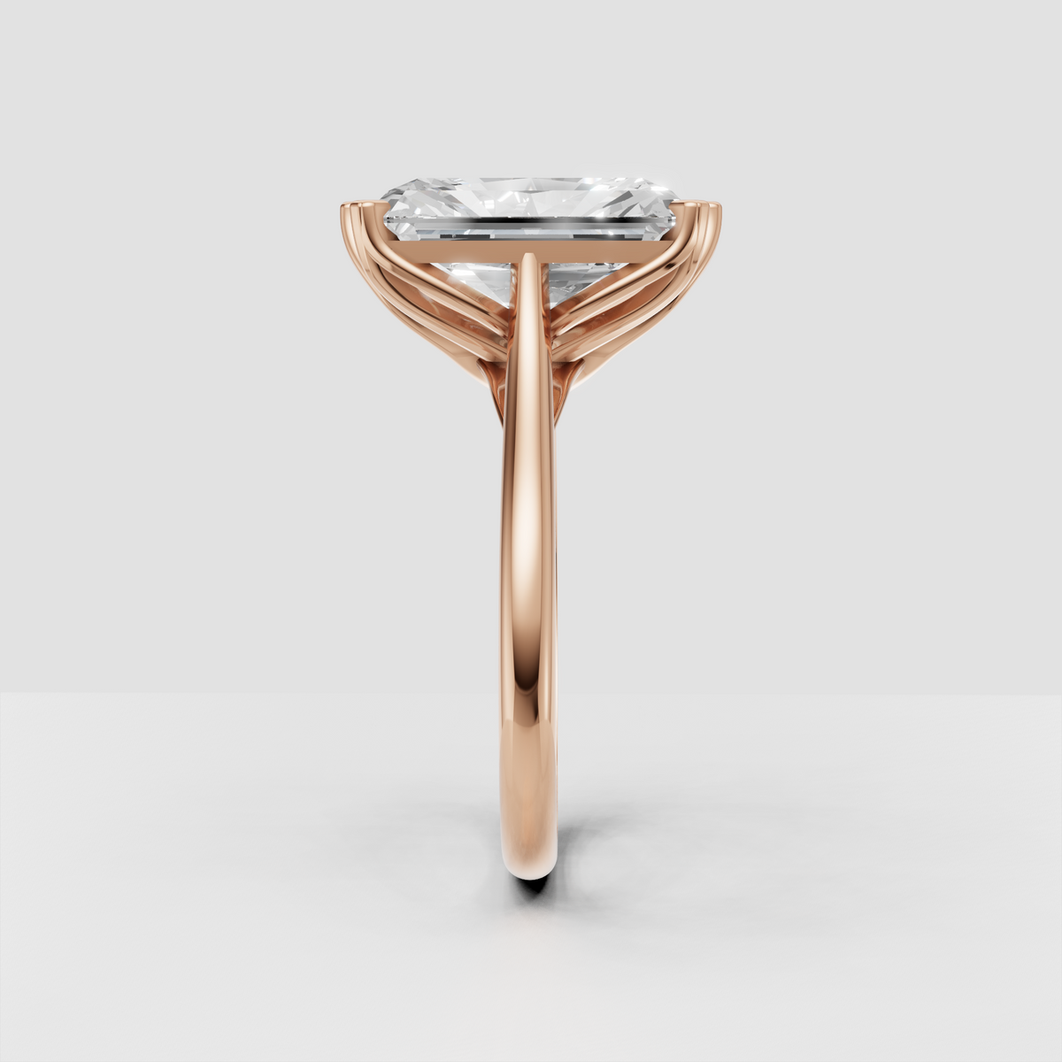 Side view of radiant diamond cathedral engagement ring with openwork gallery