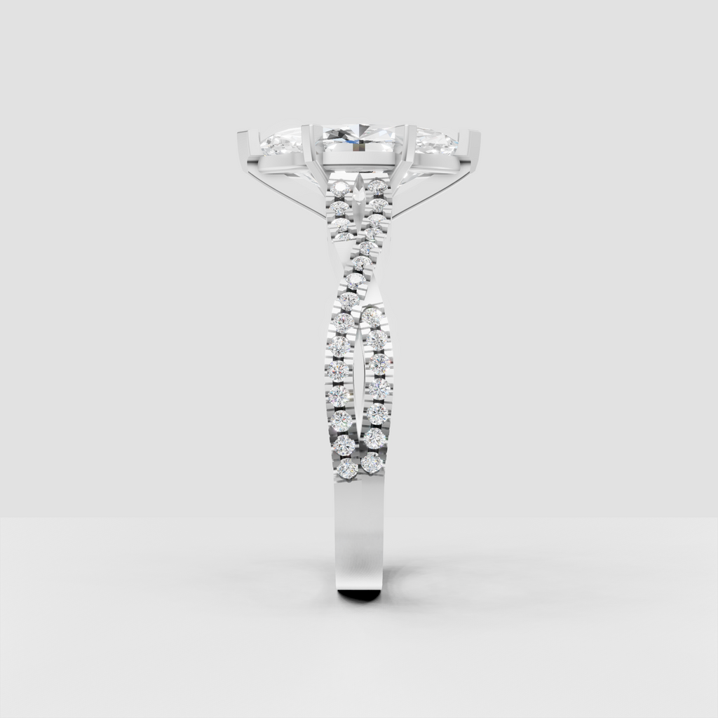 Close-up marquise shaped diamond ring showcasing six-prong center setting and cathedral-style shoulders.