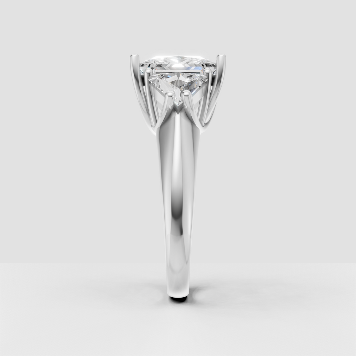 Three stone princess cut diamond ring with tapered side stones