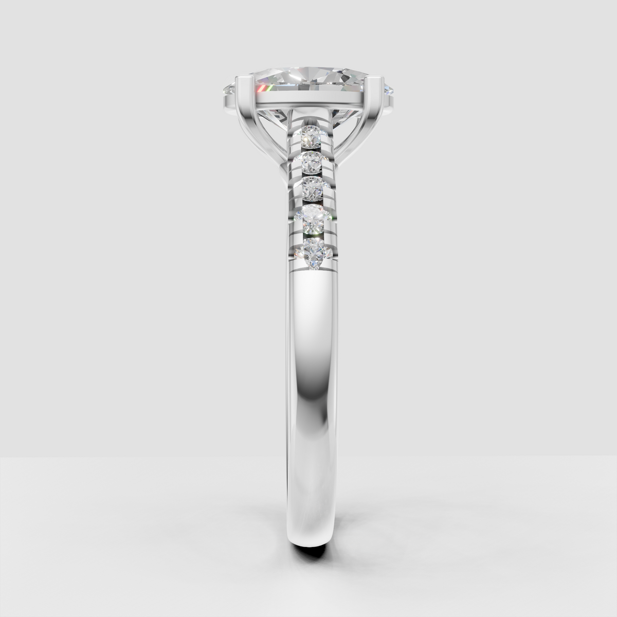 Oval diamond ring with four-prong solitaire setting and pavé band