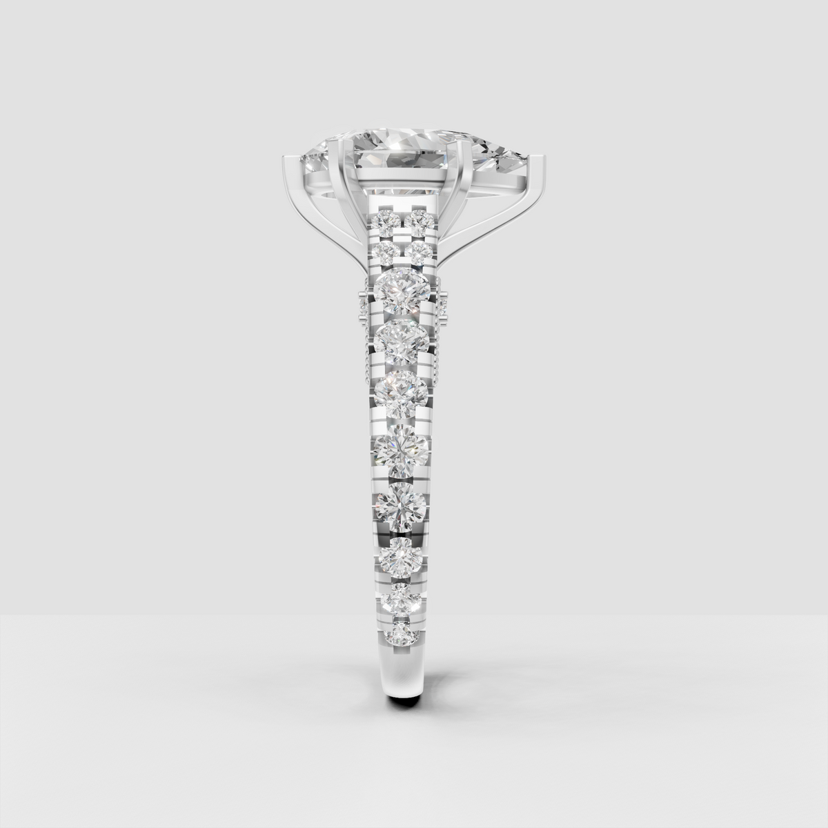 Pear diamond ring featuring six sculpted prongs and round side stones