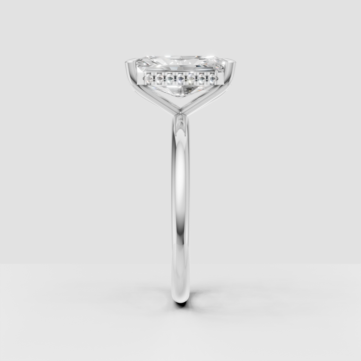 Rectangular radiant cut diamond solitaire with yellow gold band