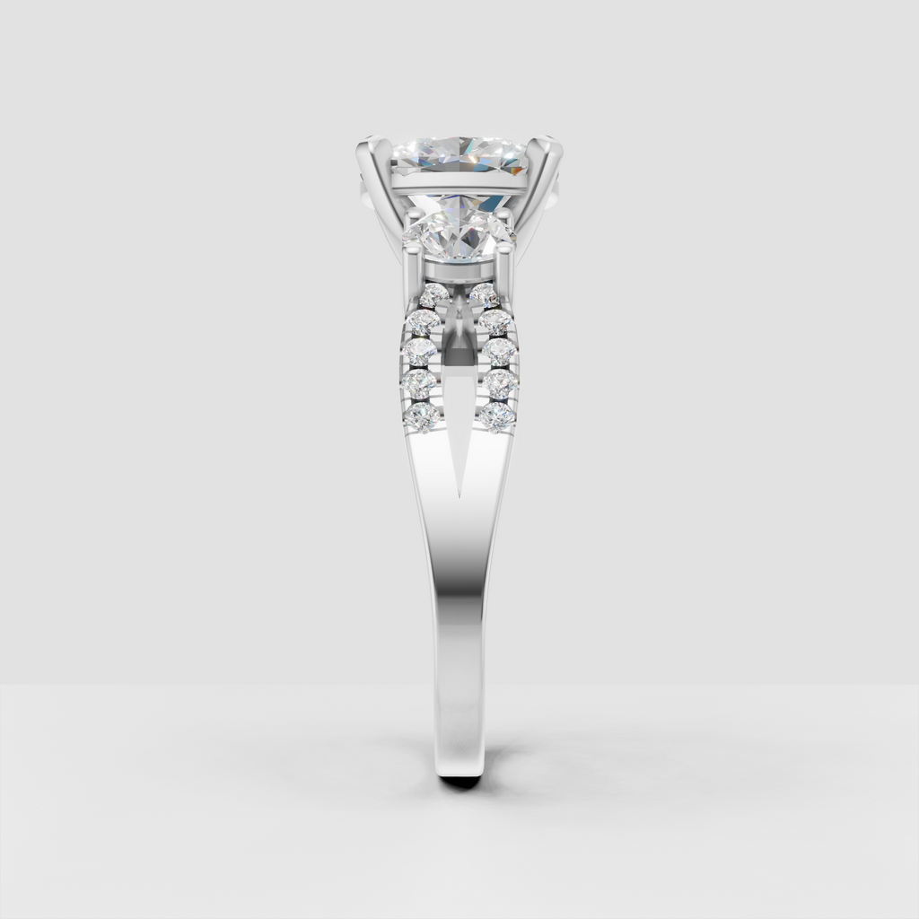Three stone engagement ring featuring oval center and oval side stones