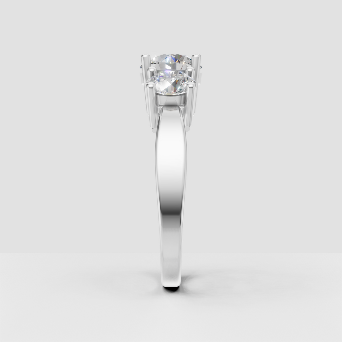 Three round diamond ring featuring a larger center stone