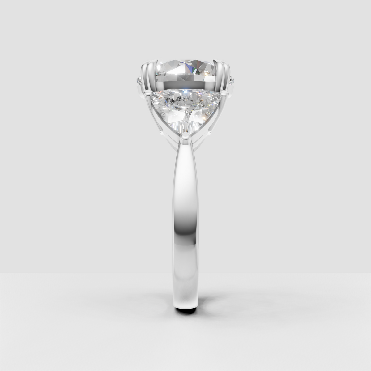 Round diamond bridal ring with three stone arrangement and decorative gold prongs