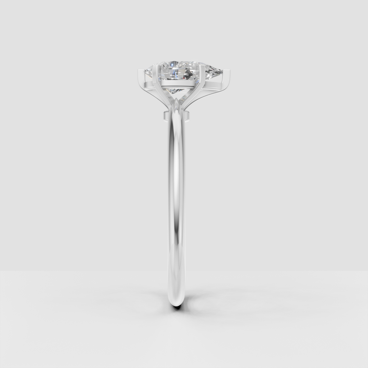 Side view of pear diamond cathedral setting engagement ring