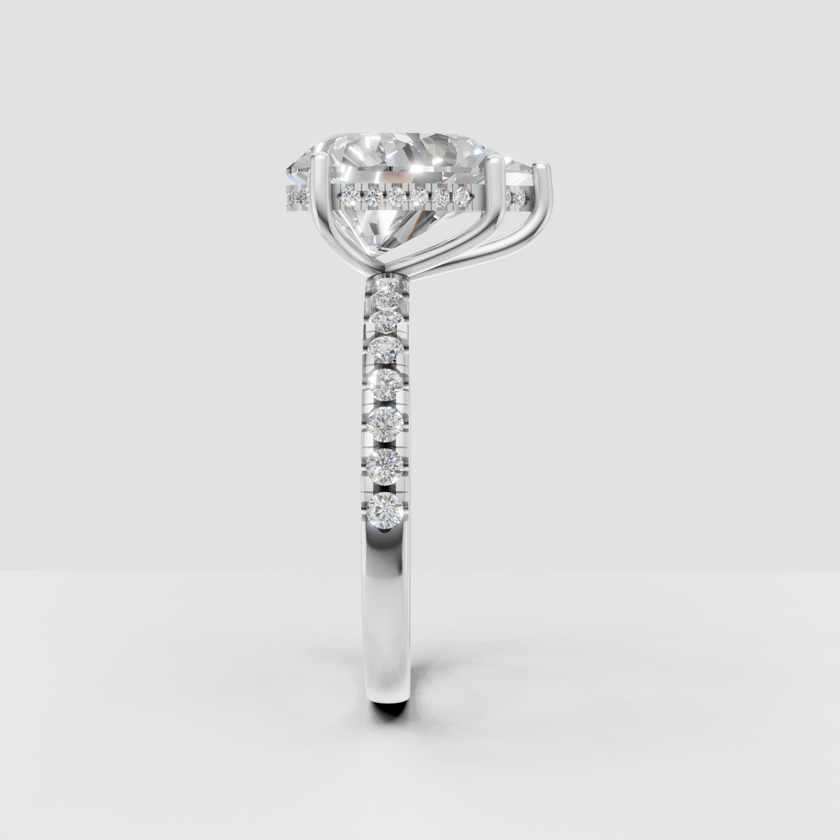 Pear diamond ring with diamond-set shoulders