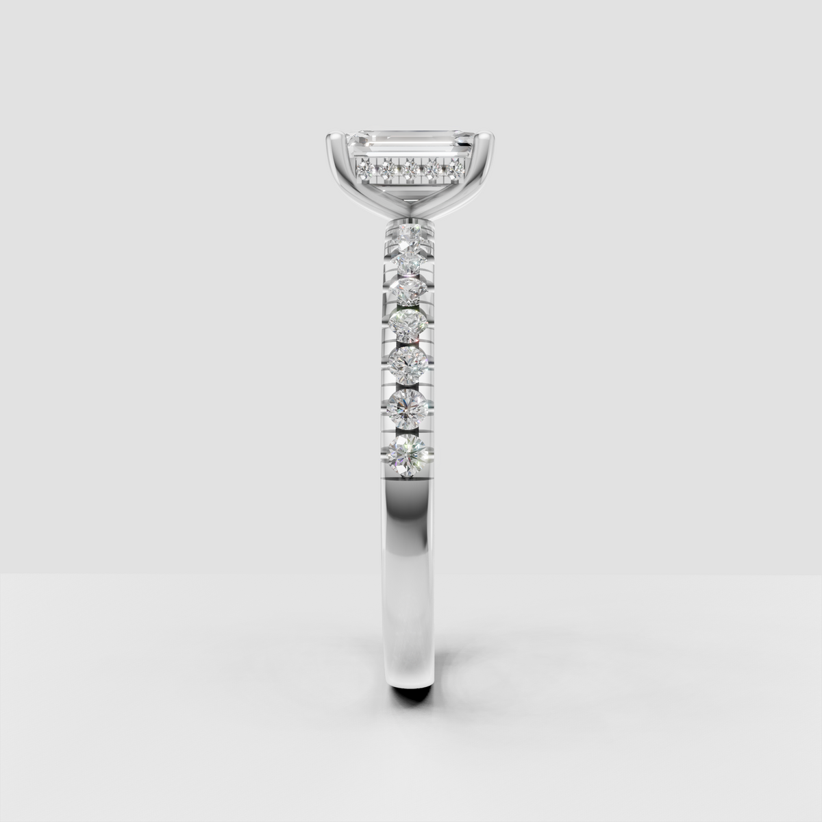Elegant emerald cut diamond ring with round diamond accented band