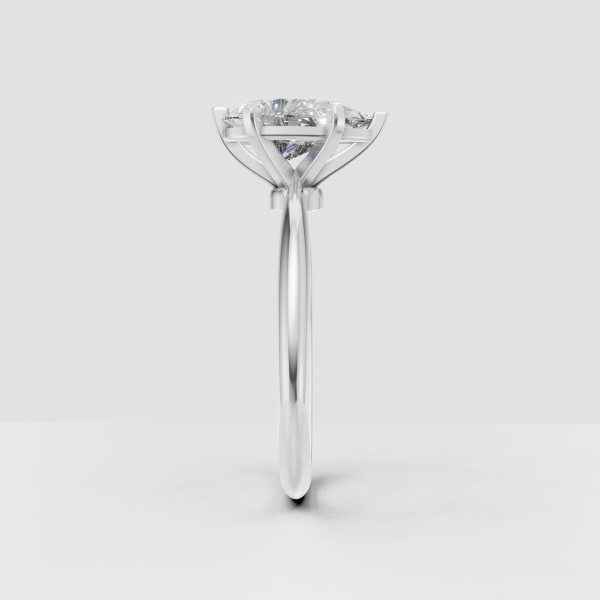 Pear-shaped center diamond secured by six rose gold prongs