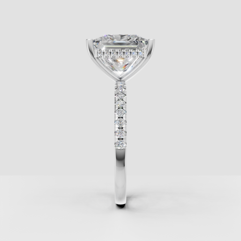 Princess diamond solitaire engagement ring with delicate pave-set round diamonds.