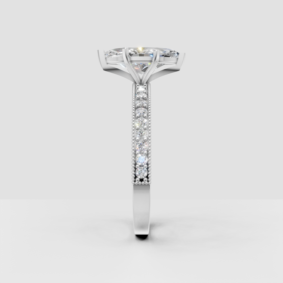 Marquise cut diamond ring featuring a slim yellow gold pavé band