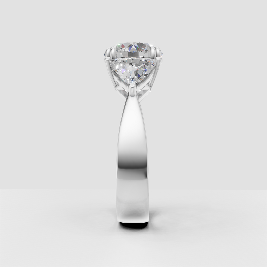 Round canter diamond with pear-shaped side stones on gold ring