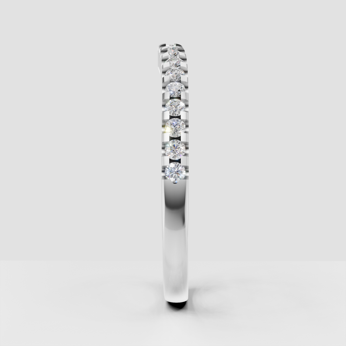 Polished yellow gold eternity band featuring round diamonds