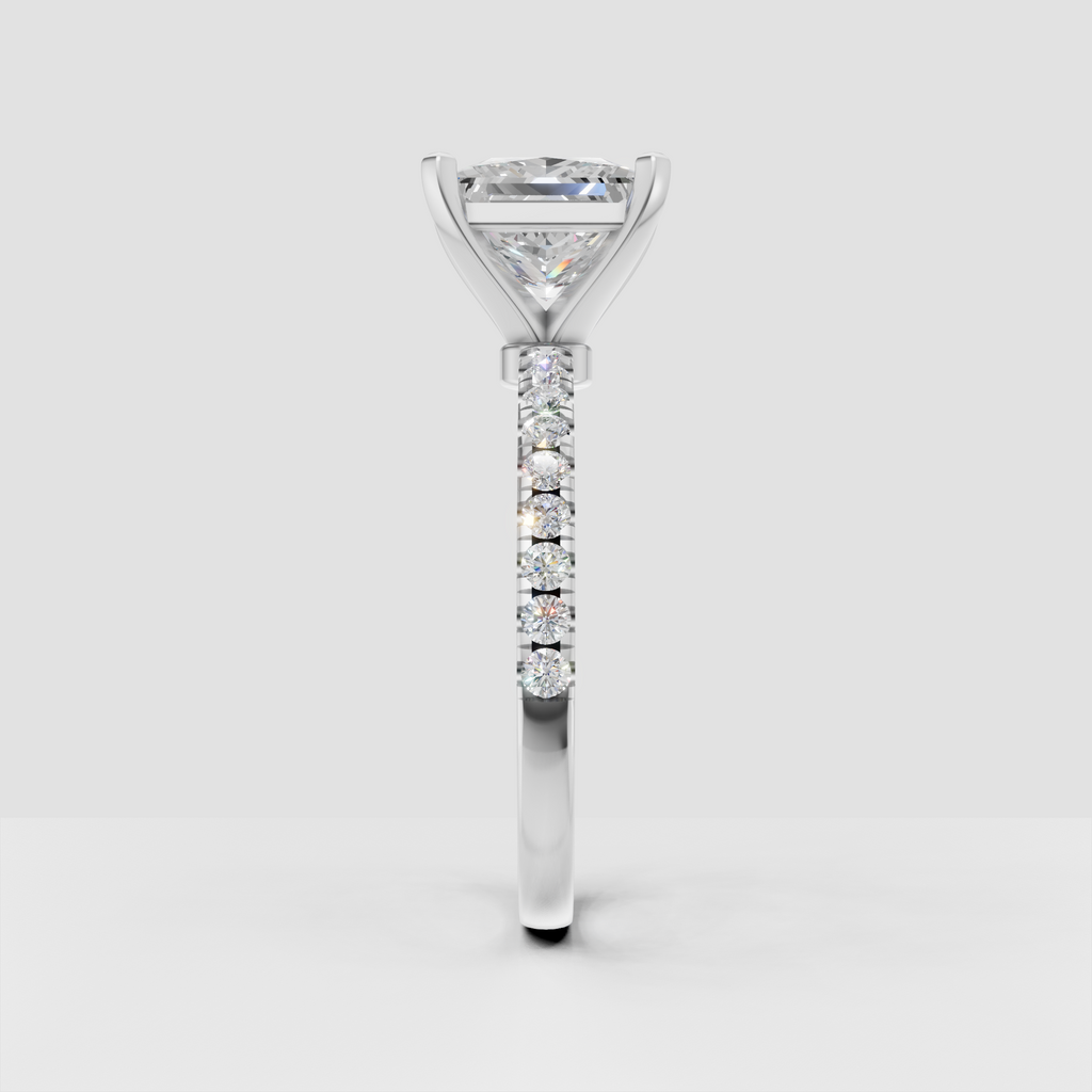 Four prong princess cut diamond ring with round accent diamonds on band
