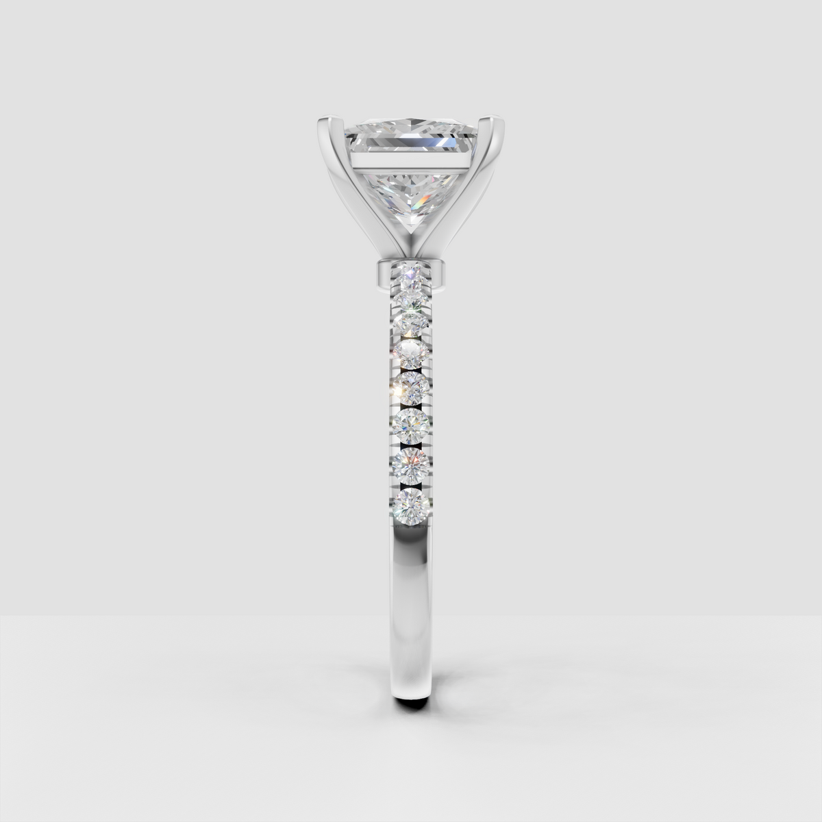 Four prong princess cut diamond ring with round accent diamonds on band