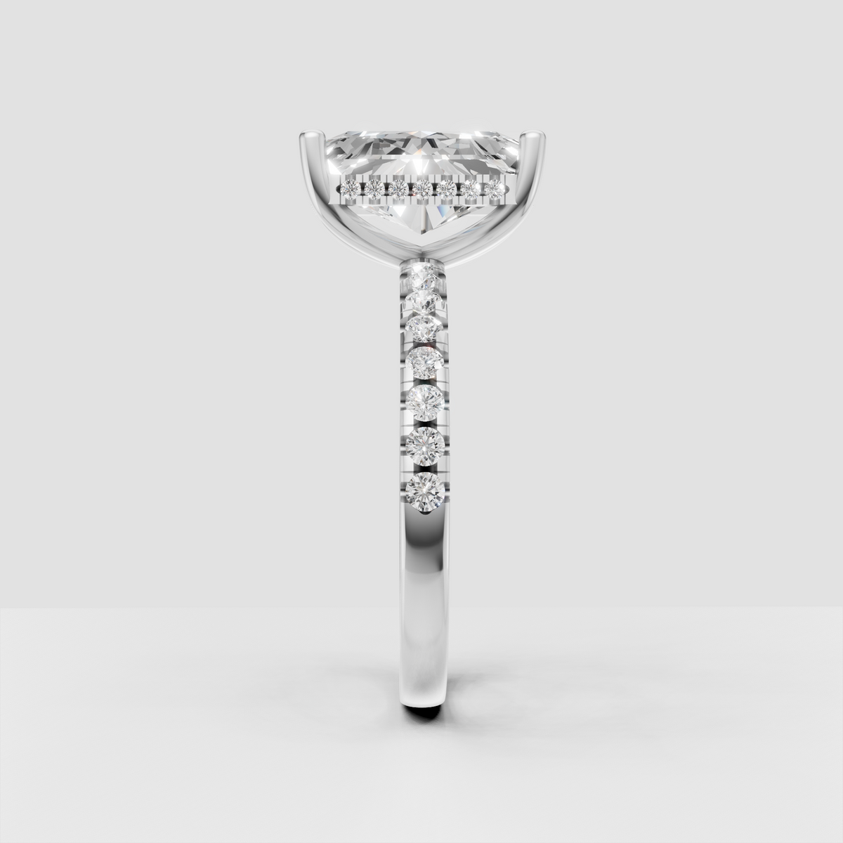 Radiant cut center diamond in four-prong yellow gold setting