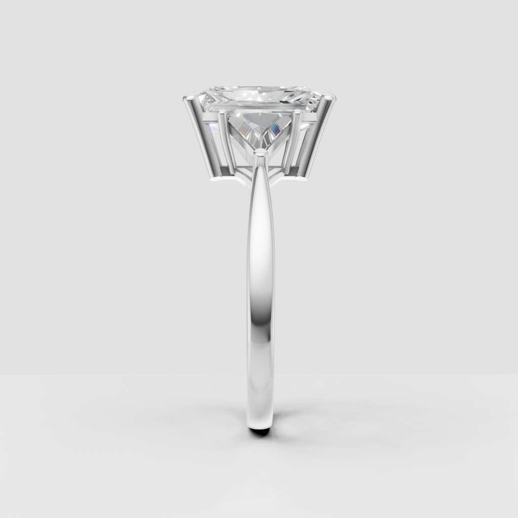 Three-stone radiant diamond engagement ring with architectural gold setting