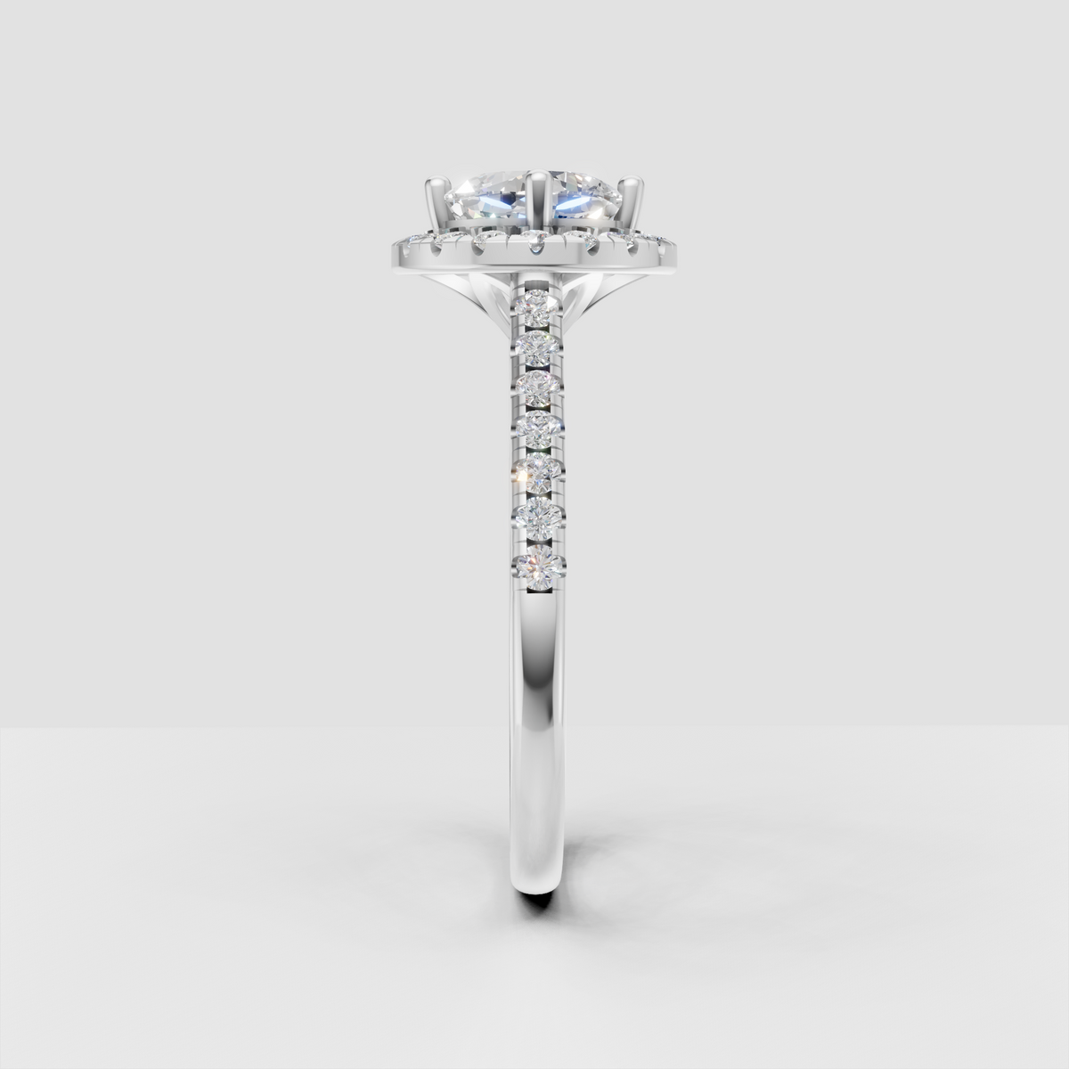Halo cushion diamond ring with round accent stones surrounding the center