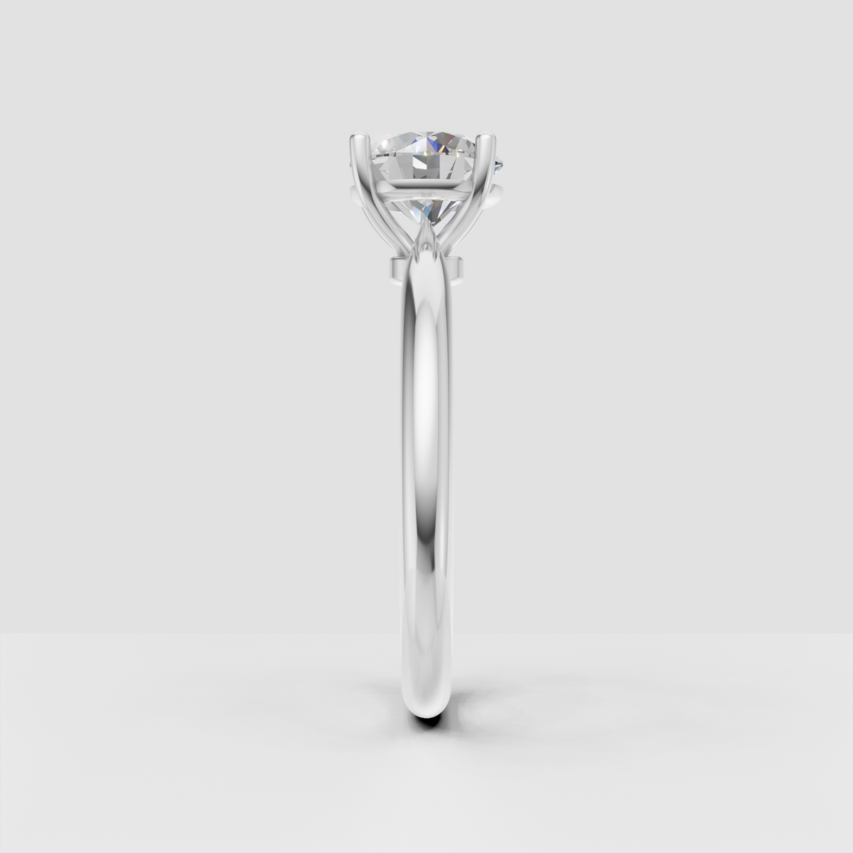 Round diamond solitaire ring with elevated gallery and four prong setting