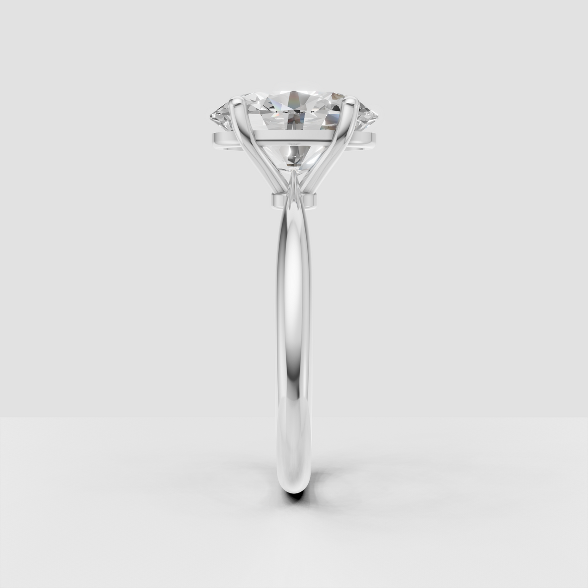 Polished yellow gold engagement ring with elongated oval Diamond center stone