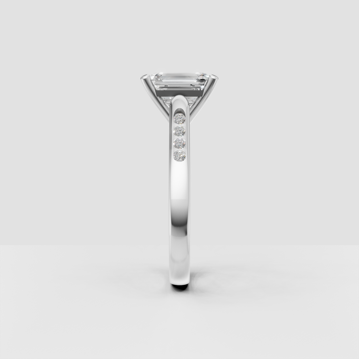 Emerald cut center diamond secured by four refined yellow gold prongs.